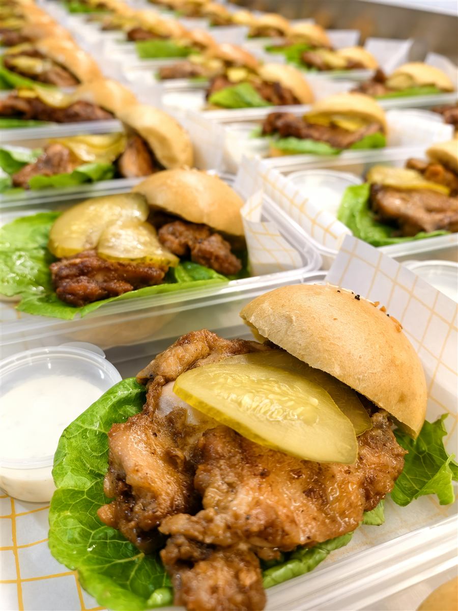 Keto burger with lettuce, tomato and sauce on a low-carb bun